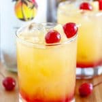 Glass with juice and cherries.
