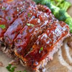 meatloaf on parchment paper with broccoli