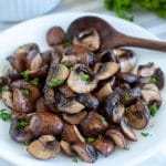 Cooked mushrooms on plate with spoon.