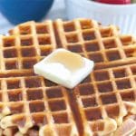 Waffles on plate with butter.