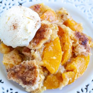 Peach cobbler with scoop of ice cream.