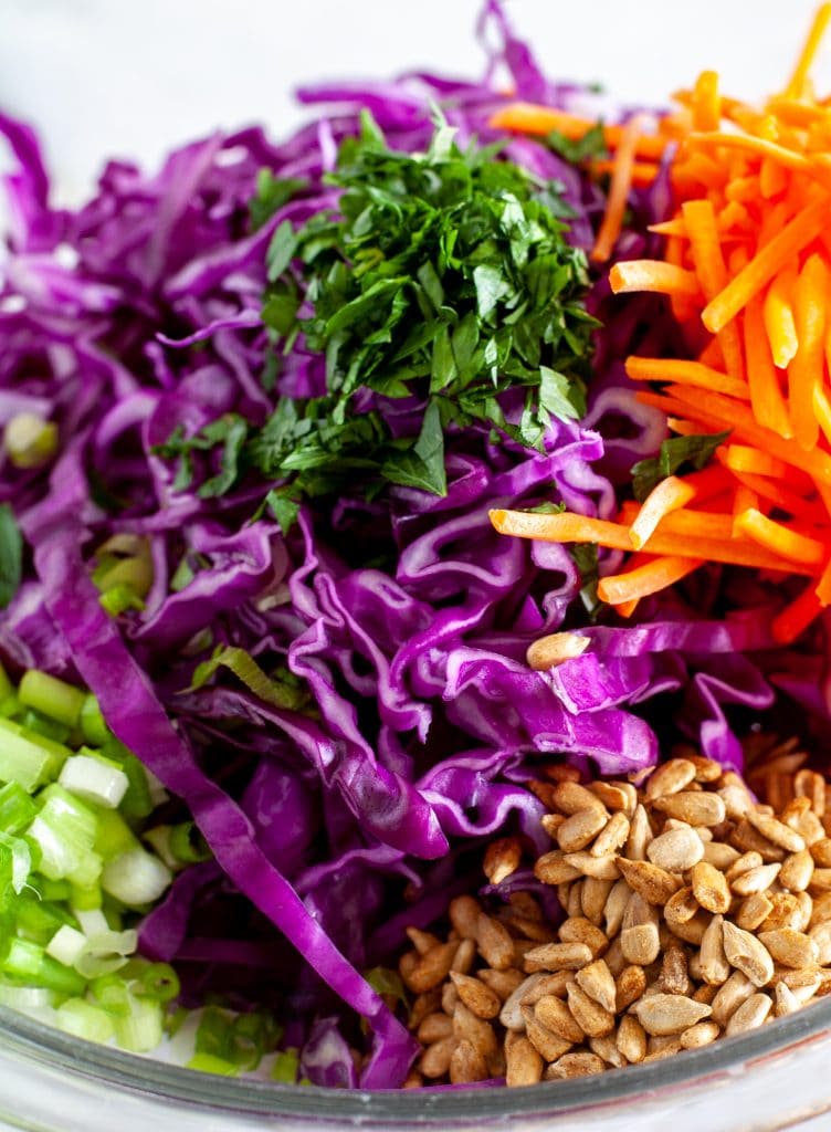 Cabbage, parsley, carrots, sunflower seeds in a bowl