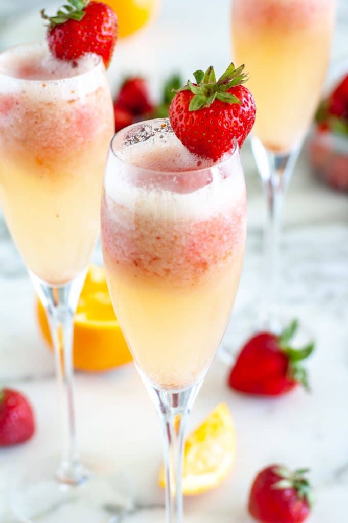 Glass of mimosa with a strawberry on top