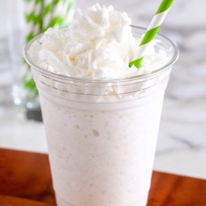 vanilla bean frappuccino in glass with green straw