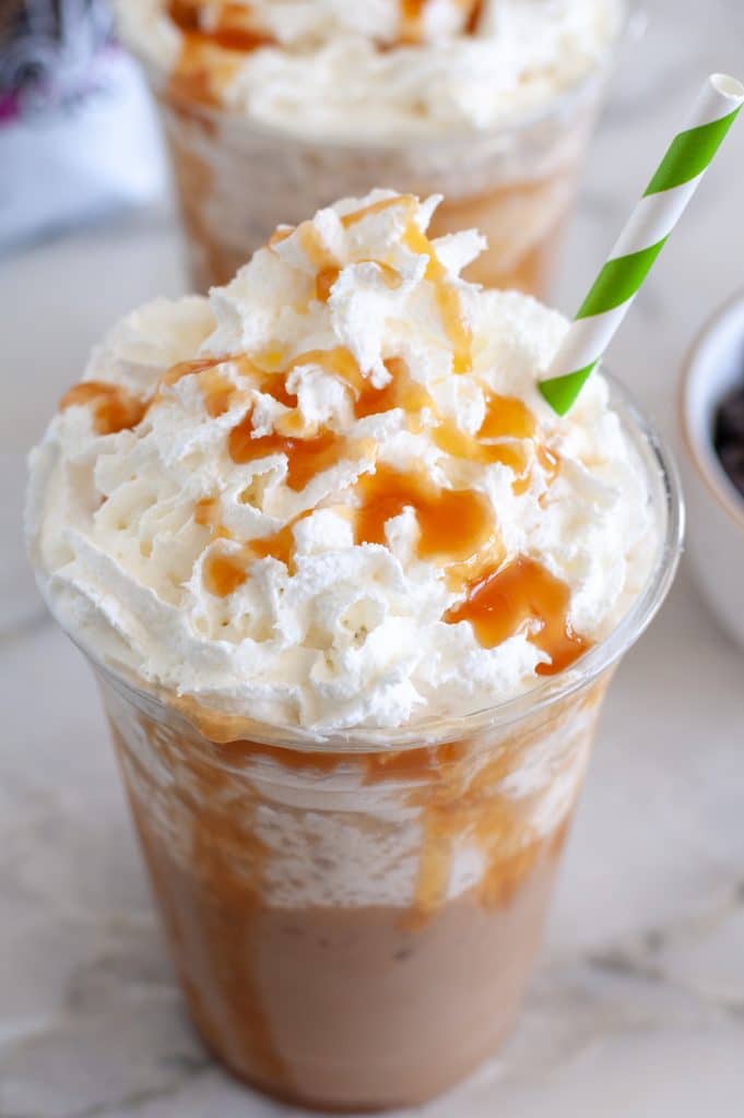 Frappuccino in a glass with whipped cream and caramel