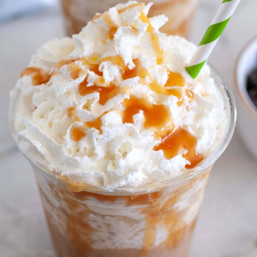 Glass of caramel frappuccino with whipped cream