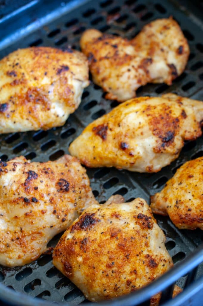 cooked chicken thighs in air fryer basket