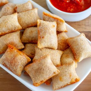 Pizza rolls on plate with sauce