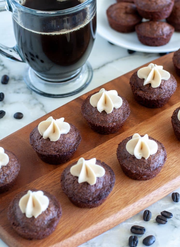 Brownies on a plate with frosting on top