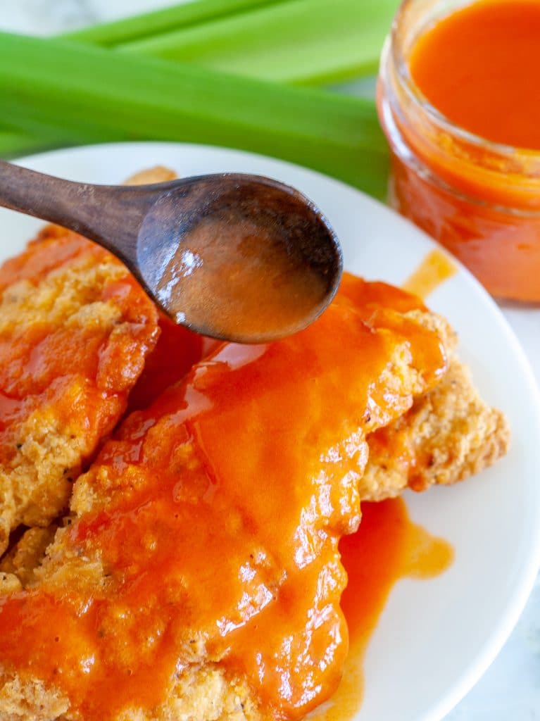 Spoon with buffalo sauce with chicken