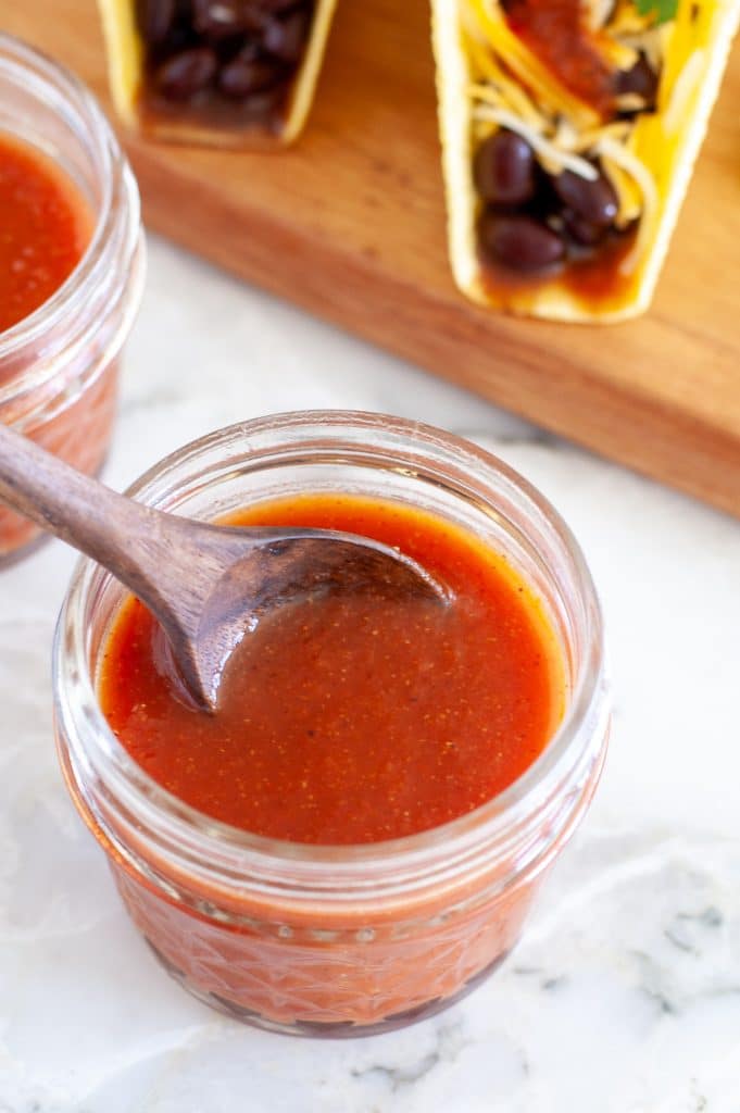 Jar of sauce with wooden spoon