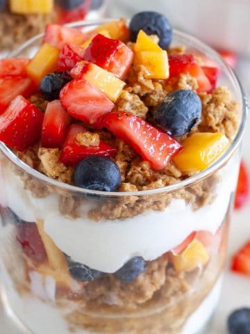 Yogurt parfait in a glass with granola and berries