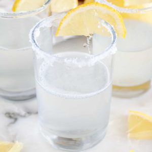 Glass with vodka and lemon.