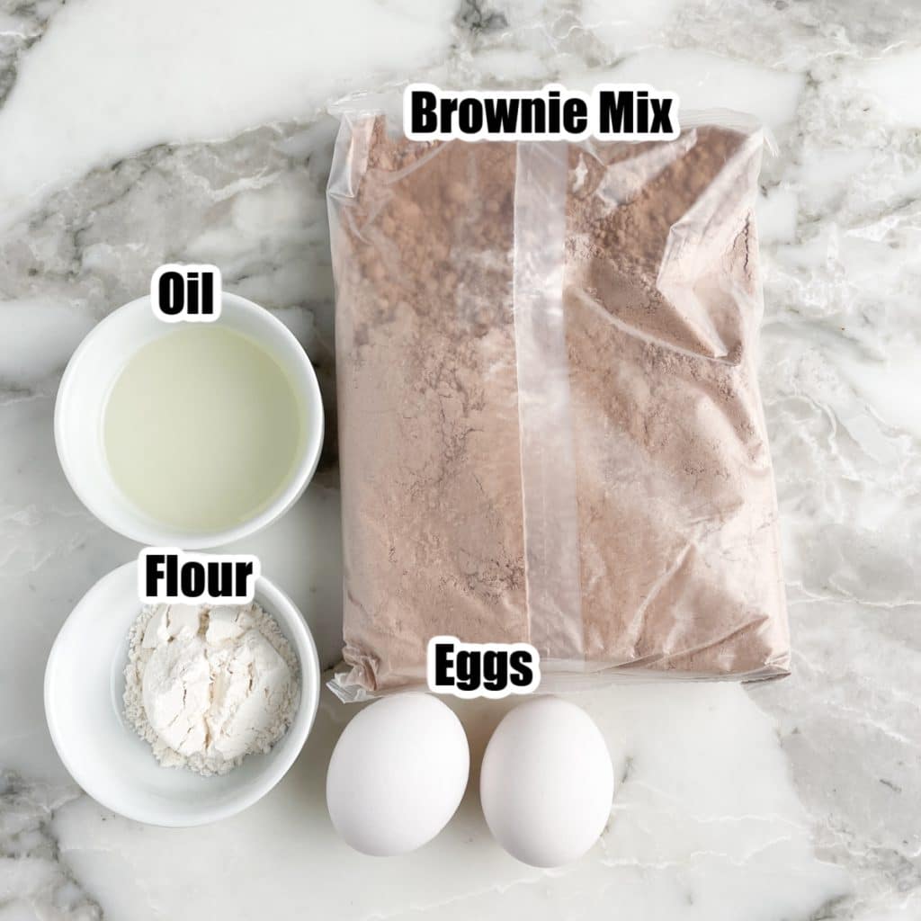 Bag of brownie mix, bowl of oil, flour, and eggs. 