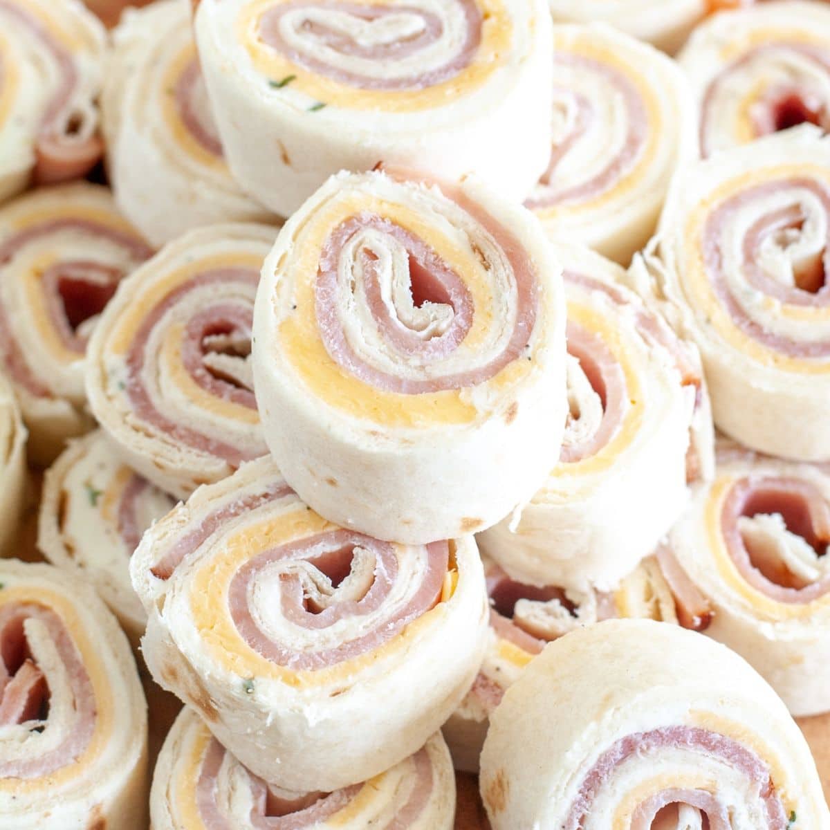 Stack of ham and cheese roll ups.