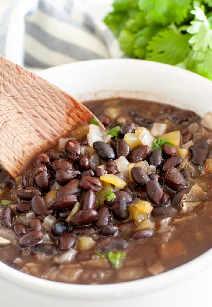 Black beans with wooden spoon