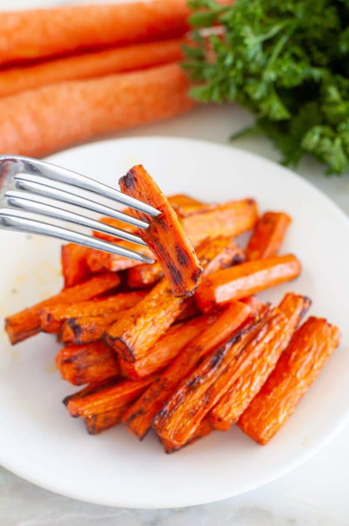 Roasted carrots with a fork