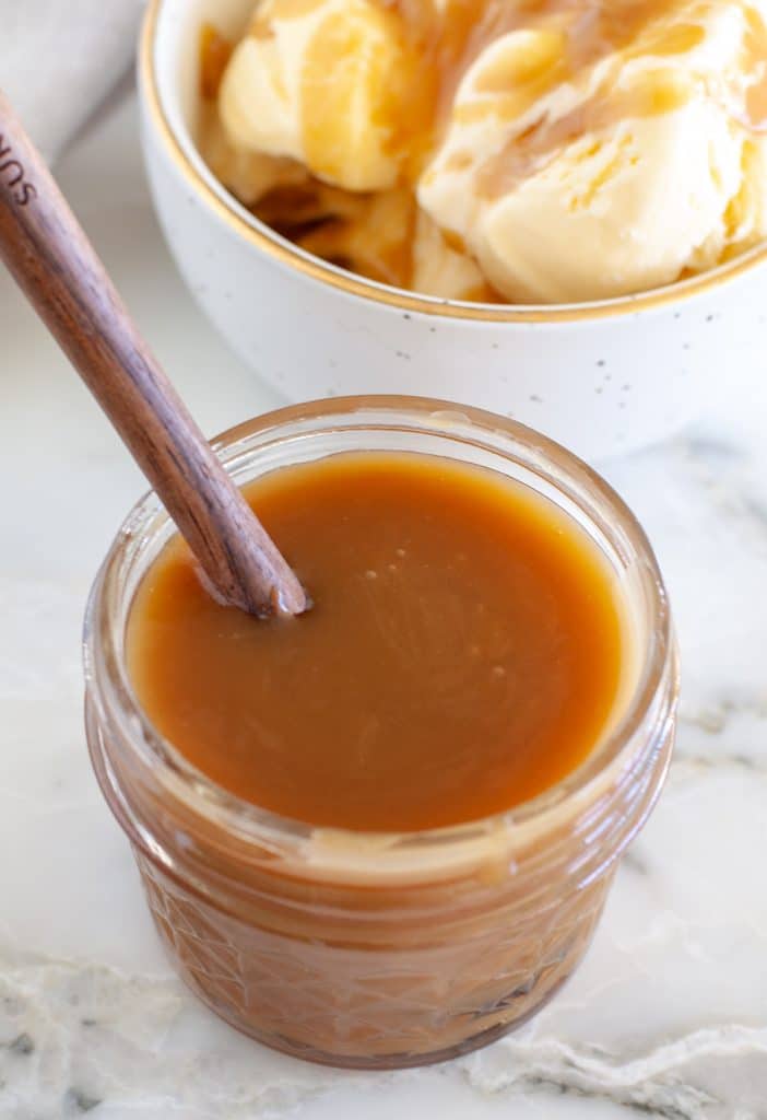 Ice cream sauce in a jar with spoon