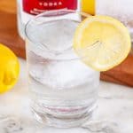 Glass with water and lemon slice.