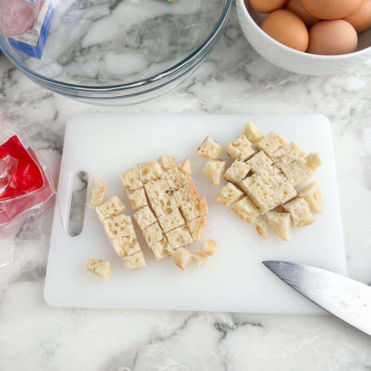 Cutting board with diced English muffins.