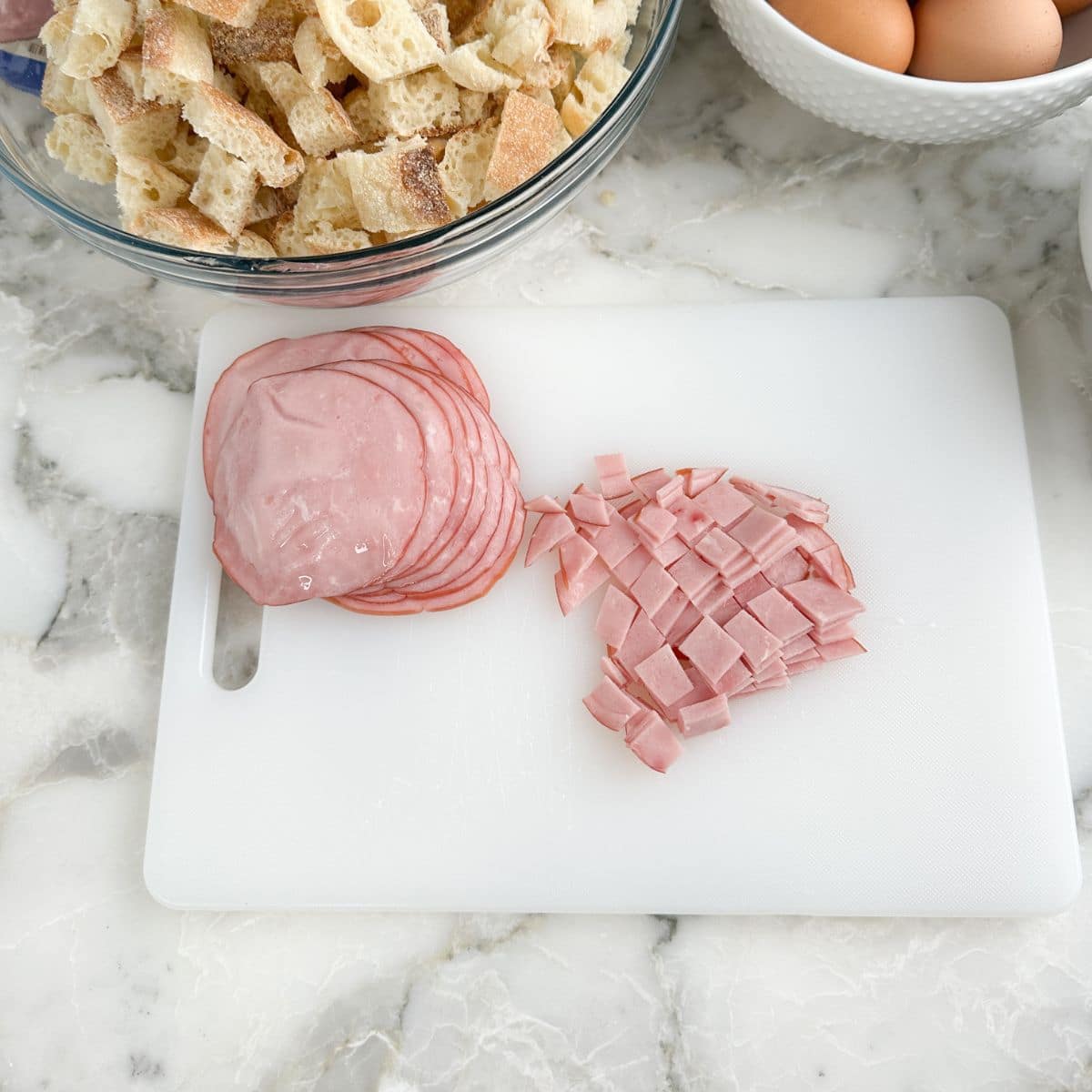 Cutting board with diced Canadian bacon.