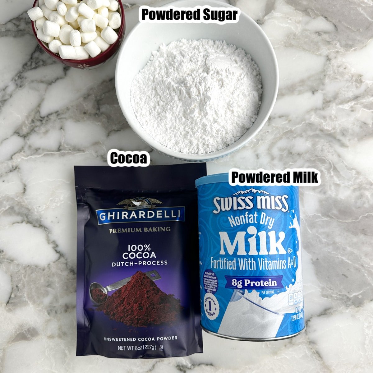 Bag of cocoa, powdered milk, and bowl of powdered sugar.