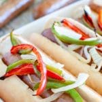 Brats in rolls with peppers and onions