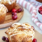 Muffin on a table with cranberries.