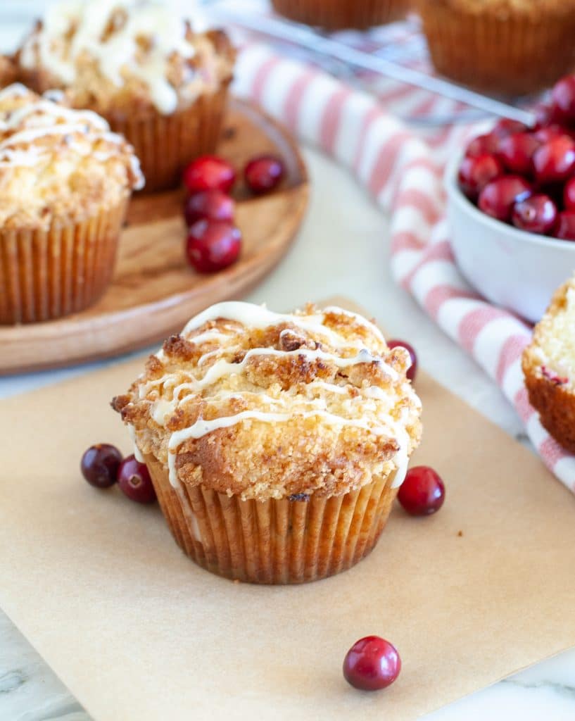 Muffin on paper with cranberries. 