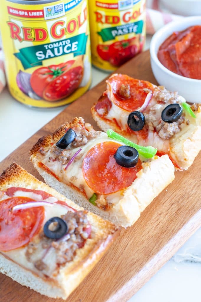 Sliced French bread pizza on board
