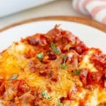 Piece of lasagna on a plate.