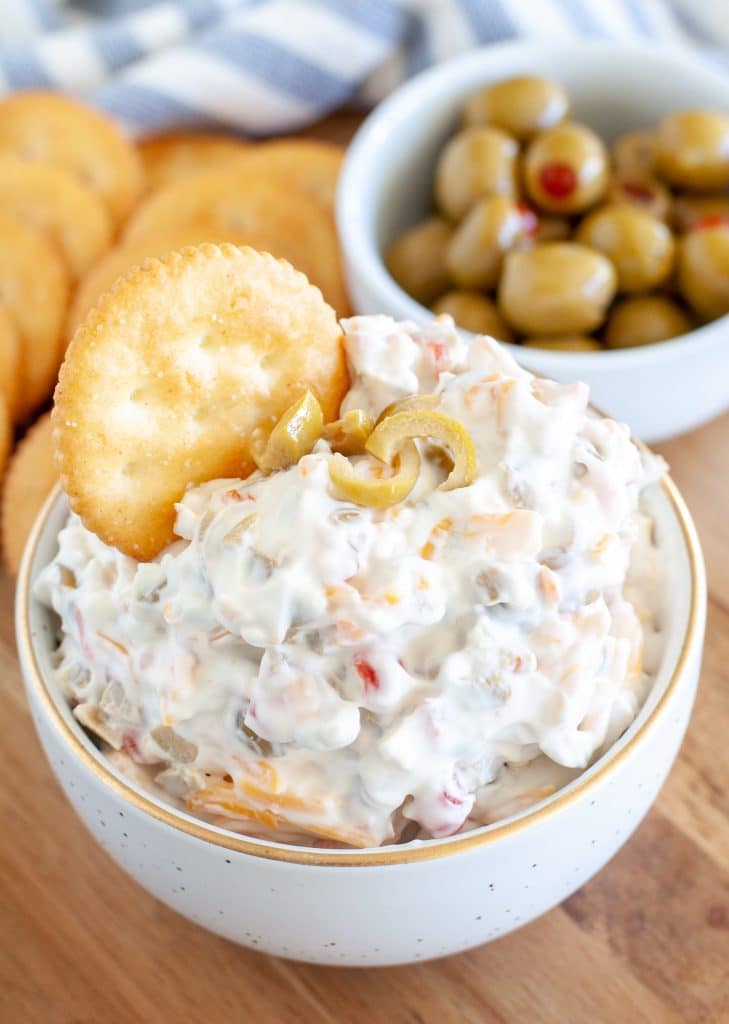 Cream cheese and olive dip with a cracker