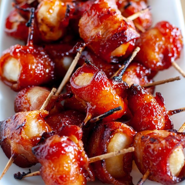Water chestnuts wrapped in bacon on plate