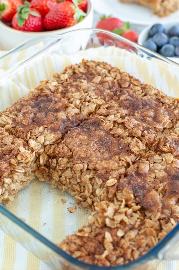 Cooked oatmeal in a casserole dish with piece missing. 