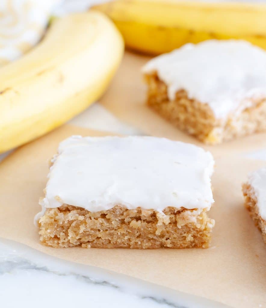 Piece of cake with vanilla frosting and banana. 