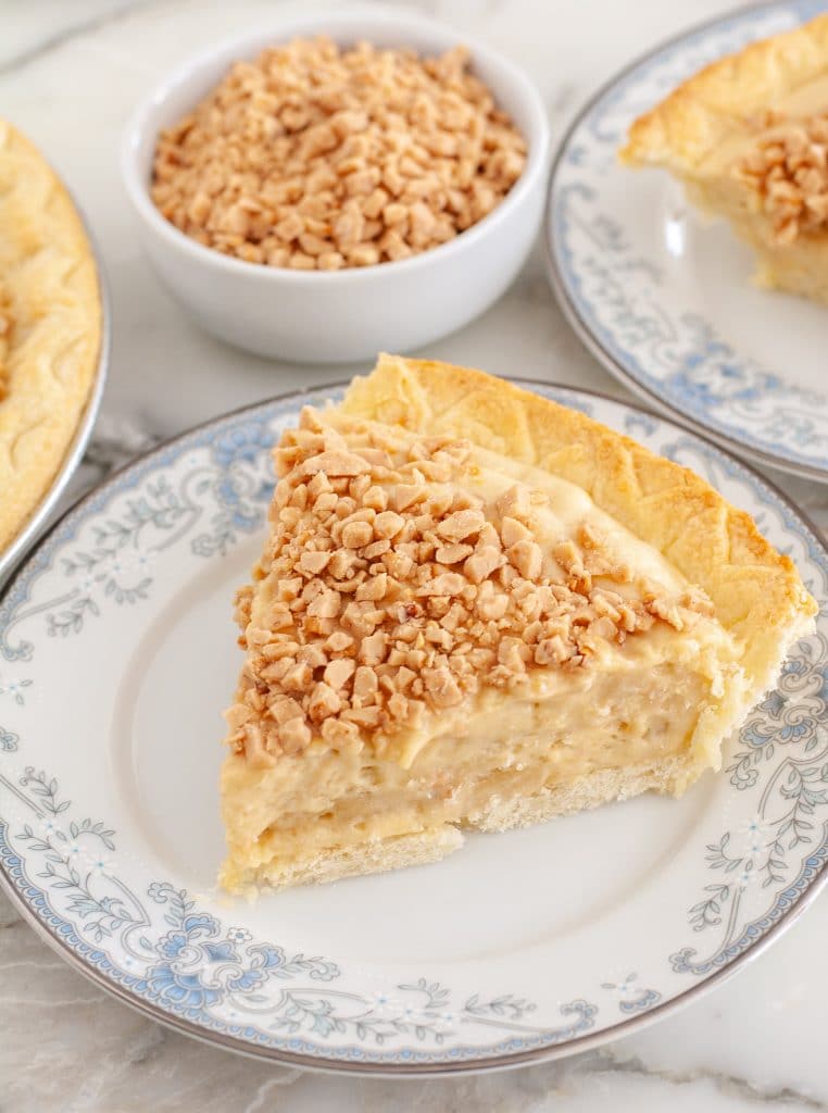 Slice of butterscotch pie on a plate. 