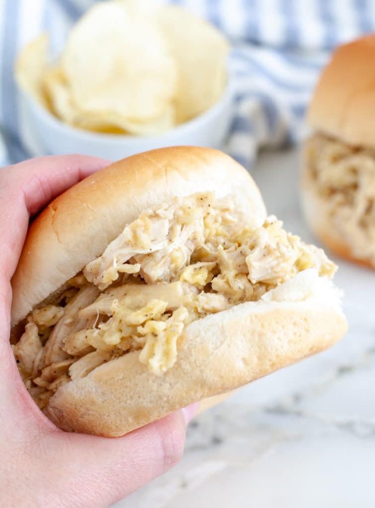 Hand holding a chicken sandwich. 