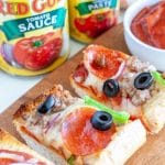 Sliced pizza on a board.