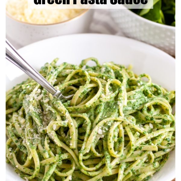 Bowl of pasta with green sauce.