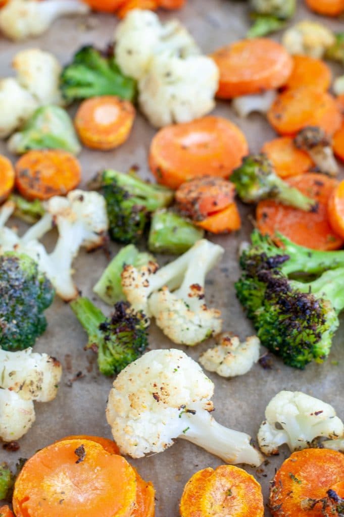Roasted mixed vegetables on a sheet pan. 