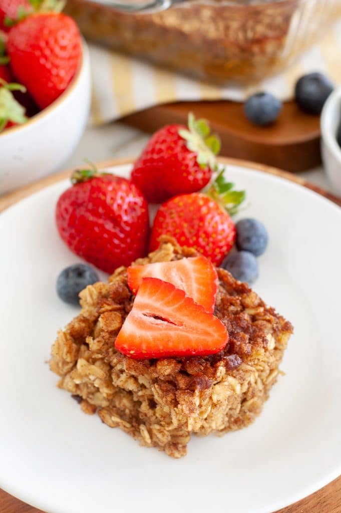 Square of baked oatmeal with strawberries and blueberries.
