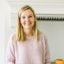 A woman standing in kitchen.