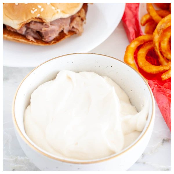 bowl of cream sauce with roast beef sandwich