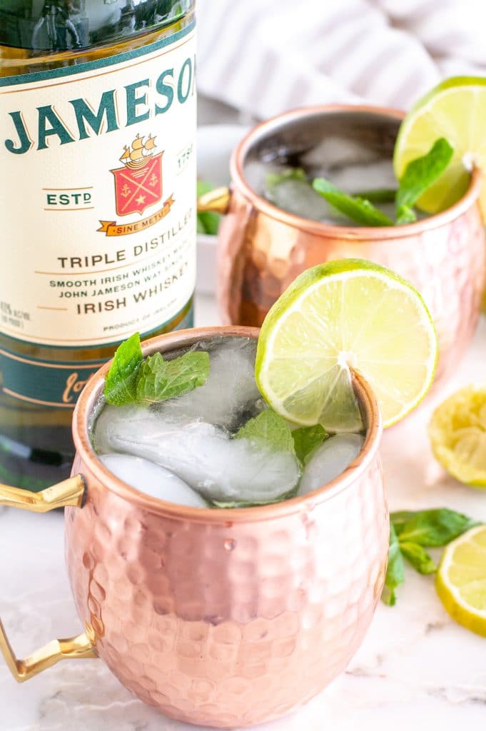 Bottle of Jameson with 2 copper cups.