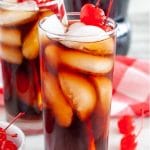 Glass with cola and cherry.