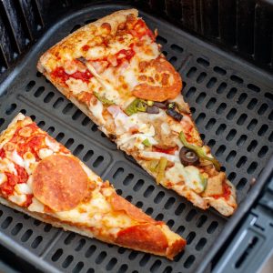 Pizza sliced in air fryer basket