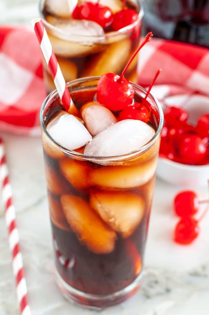 Glass filled with cola and cherries. 