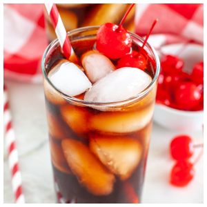 Glass with red straw and cola.