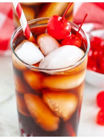 Glass with red straw and cola.