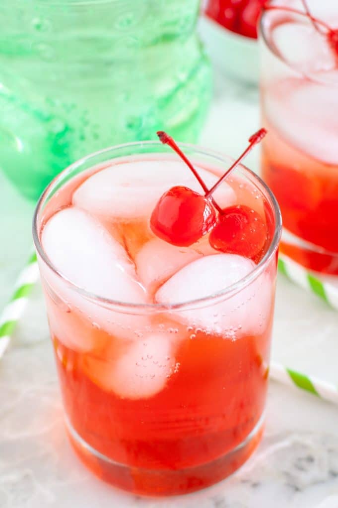 Glass with ice and cherry soda. 